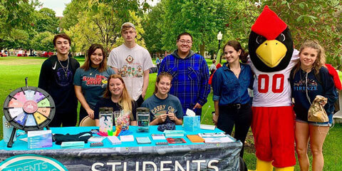 Students pose at the SERC booth on the quad.